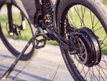Electric bike motor wheel close up with pedal and rear shock absorber