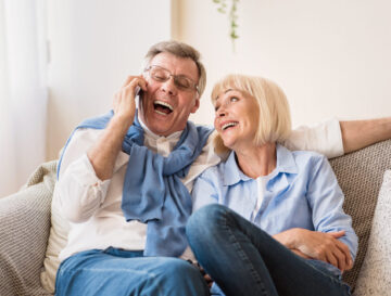 Excited senior man talking on phone