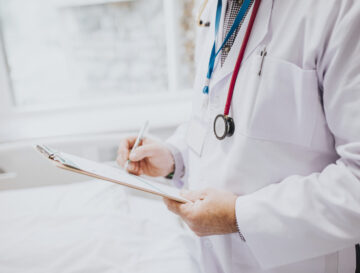 Physician noting down symptoms of a patient